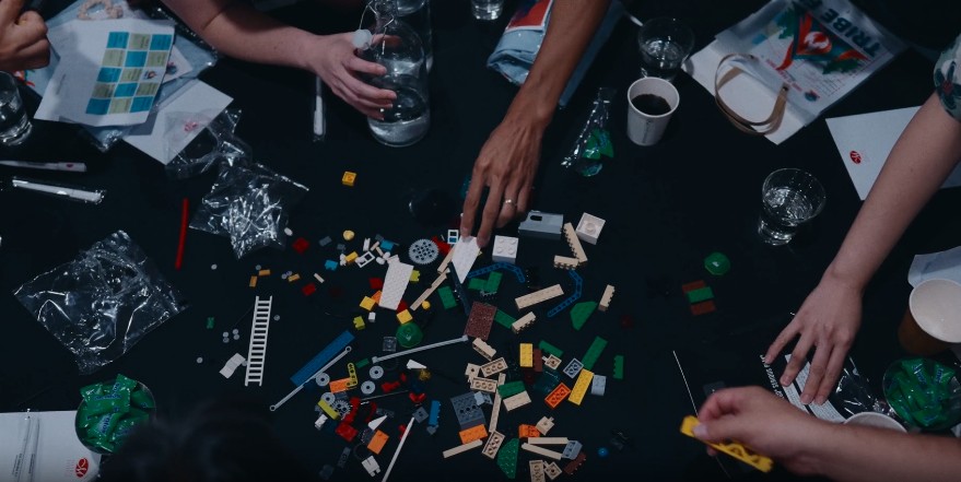 Hands building together during a team exercise on the table