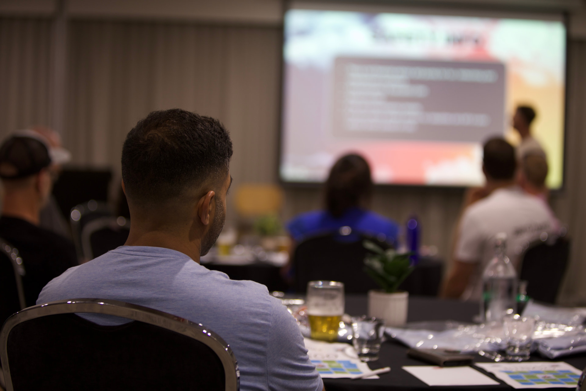 Members watching a presentation in the main session room